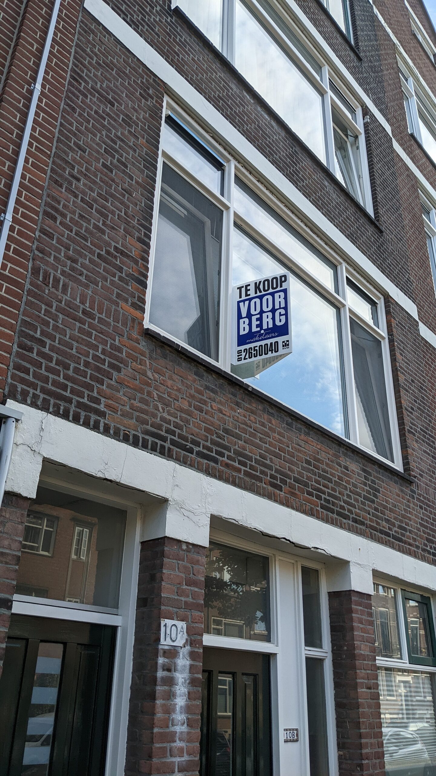 A real estate agent sign outside a house