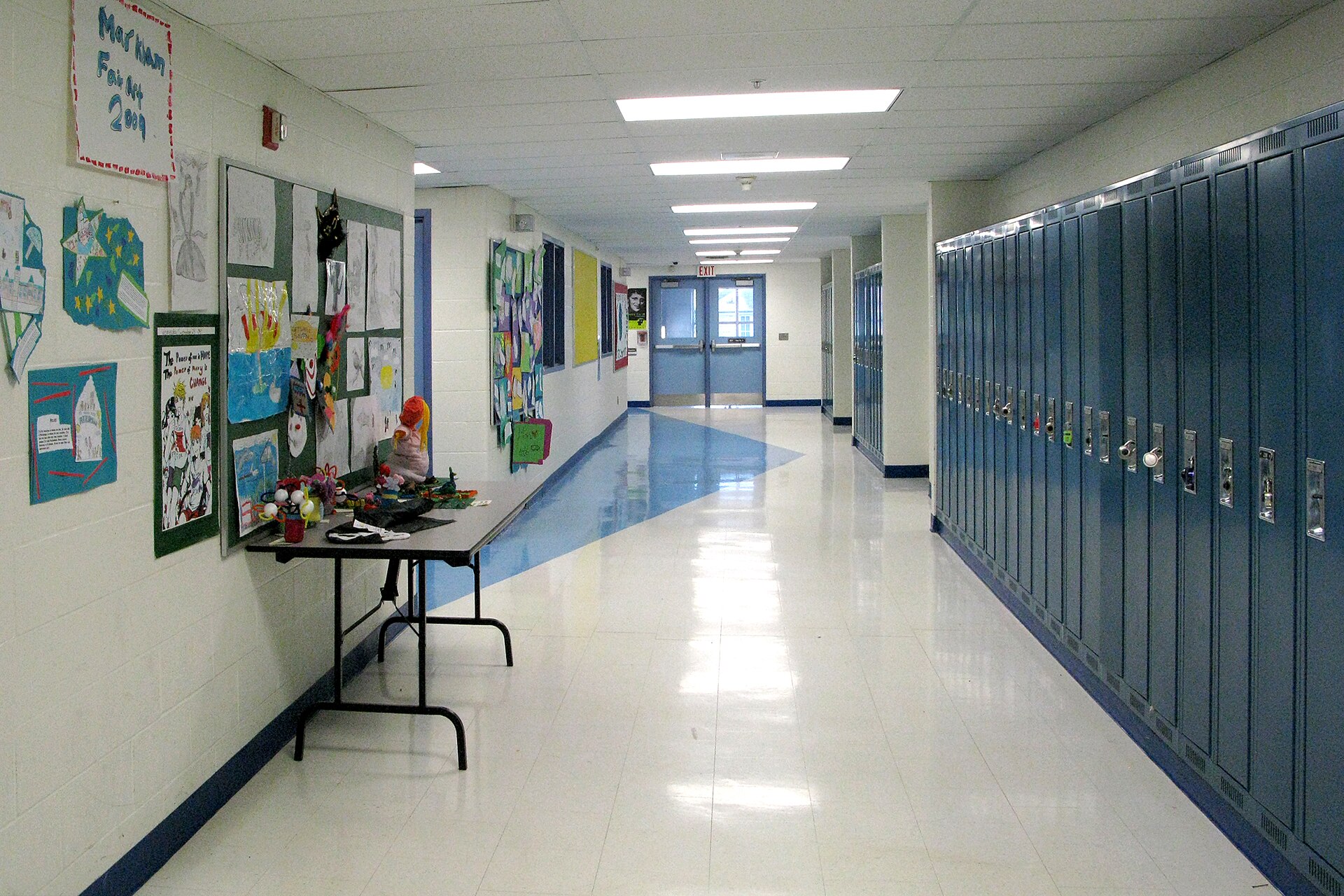 An empty school hallway lined with lockers
