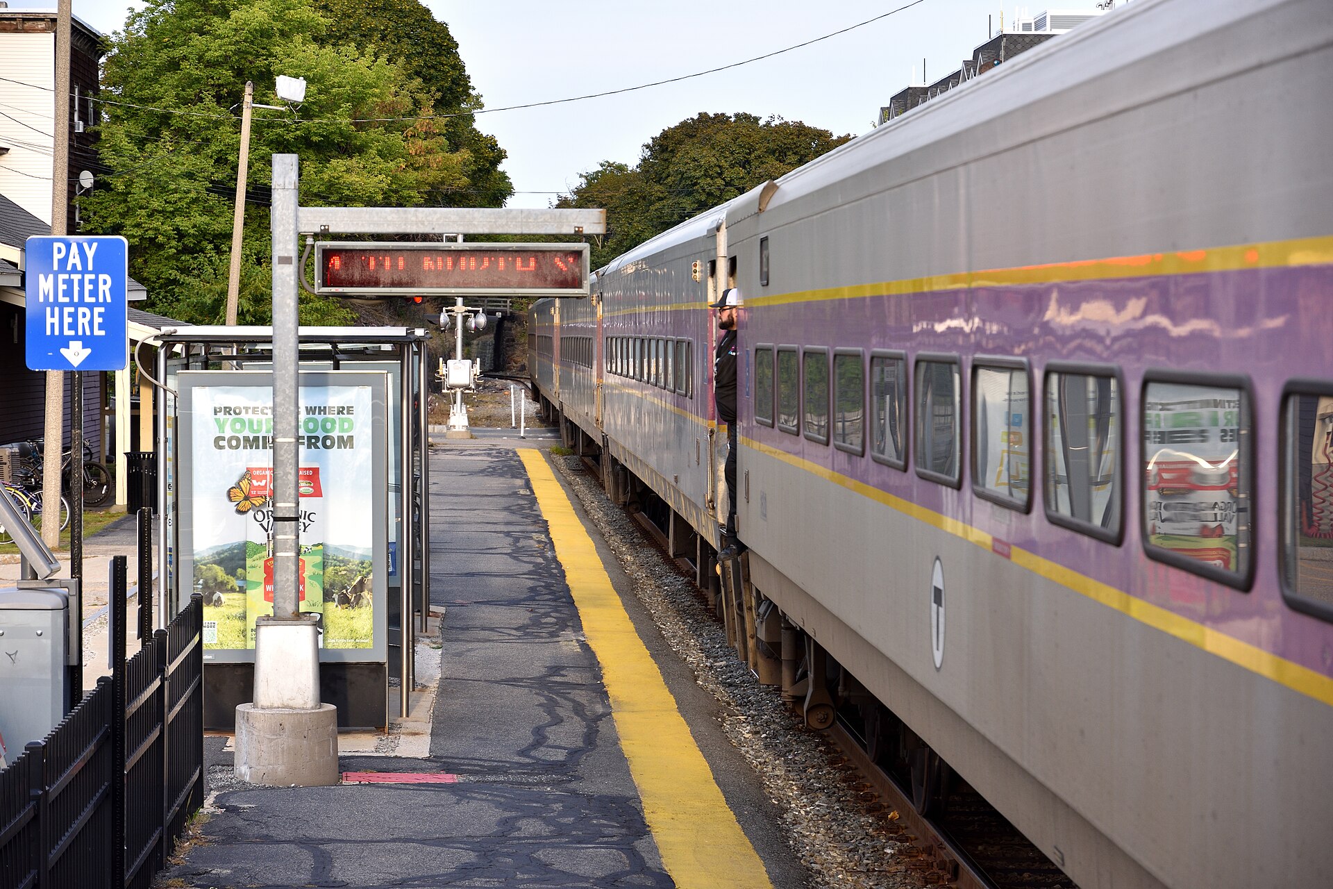 A commuter rail train at a suburban station platform